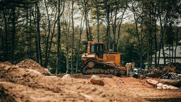 yellow and black heavy equipment on brown soil